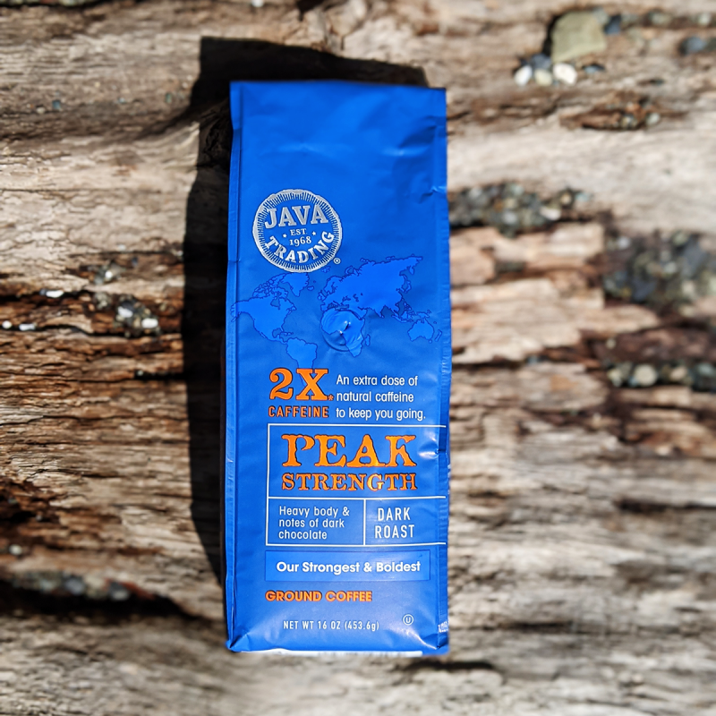 Bag of Java Trading Peak Strenght High Caffeine 16 ounces ground coffee on a wooden background