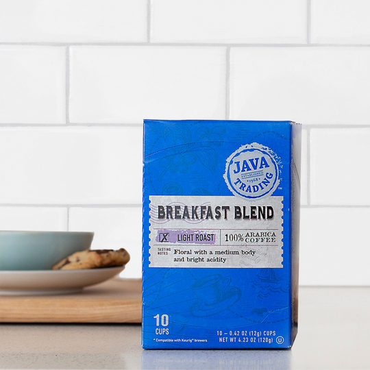 Box of 10 count Breakfast Blend coffee on a kitchen counter with cookie