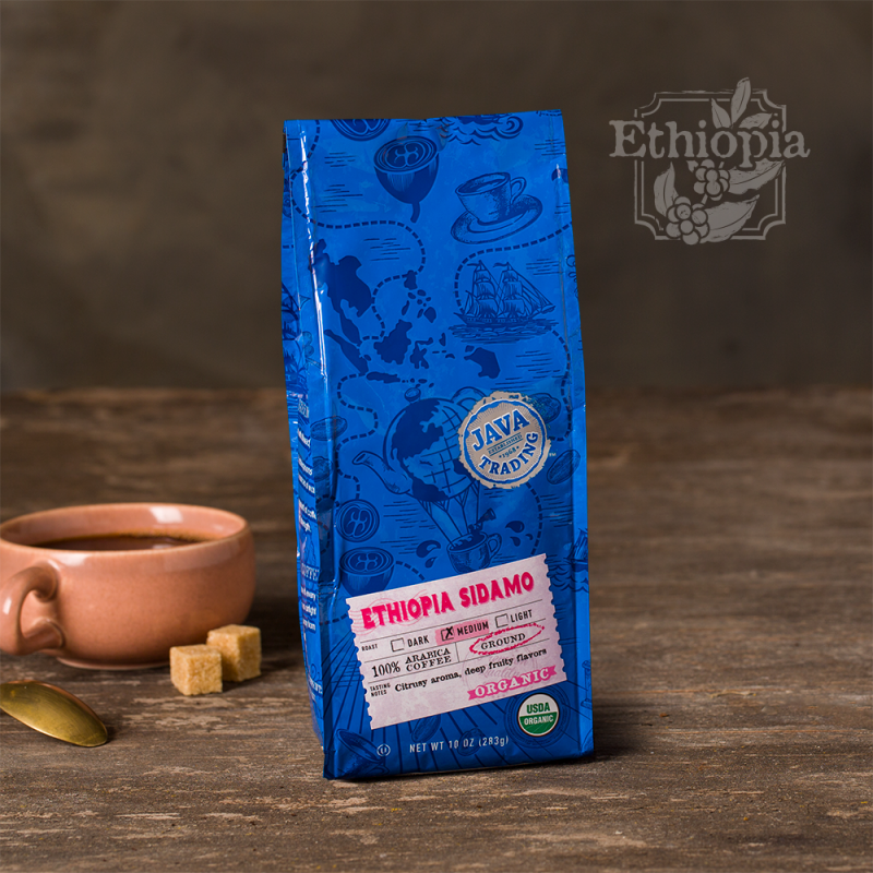 Bag of 10 ounce of Organic Ethiopia Sidamo coffee on a wooden table small pink cup
