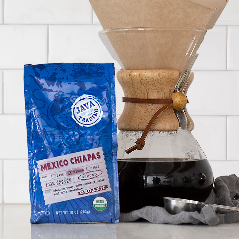 Bag of 10 ounce Organic Mexico Chiapas on a kitchen counter with a pour over brewer