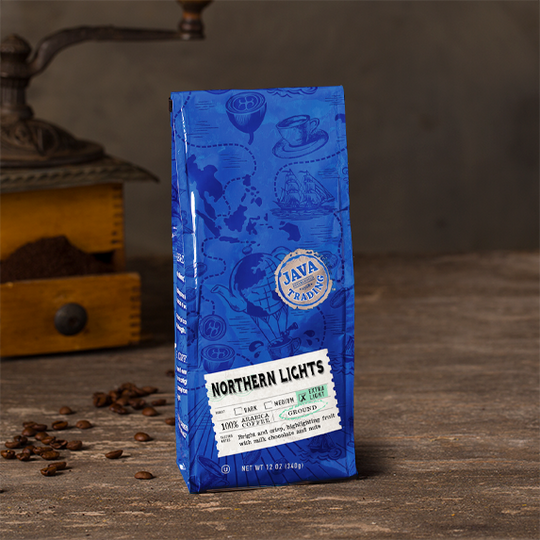Blue bag of Northern Lights Coffee Bag, extra light roast, ground, 12 ounces on a wooden table