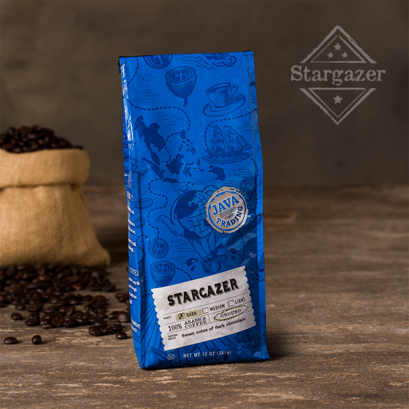 Bag of 12 ounce Stargazer coffee on a wooden table with small burlap bag filled with roasted coffee beans